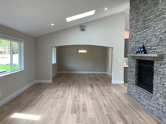 Front entry looking thru the Great room towards the Dining room. Notice double sided fireplace in the Great room