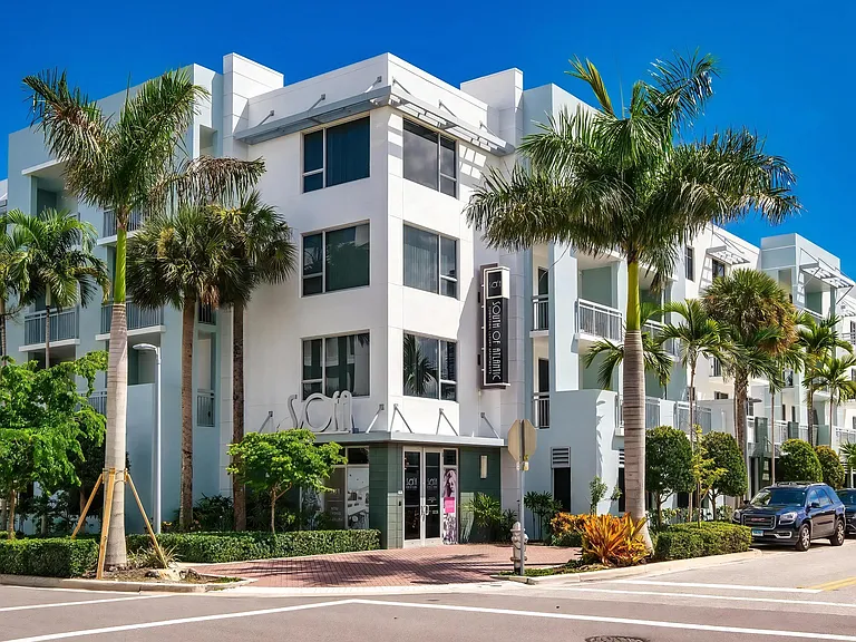 Palm-Lined Corner Entrance to South of Atlantic Luxury Apartments