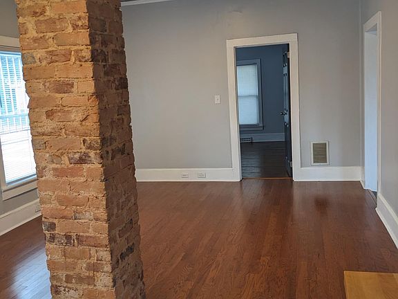 living room with door into one bedroom