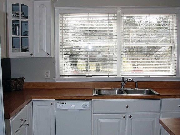 Kitchen with new tile flooring, updated cabinets and countertops.