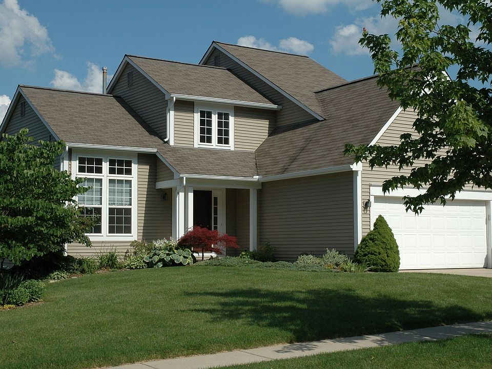 Front of house w prof landscaped gardens