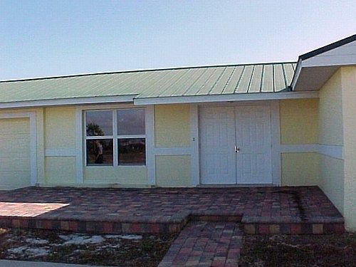Front entrance has brick paver walk and patio
