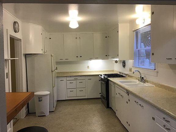 Spacious kitchen with several cabinets.