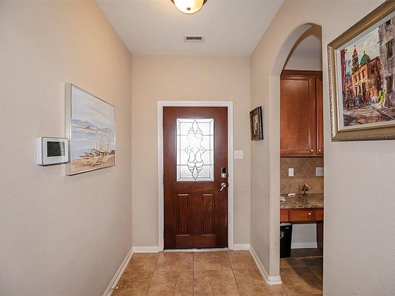 Another look at the entrway and a view into the kitchen on the right.