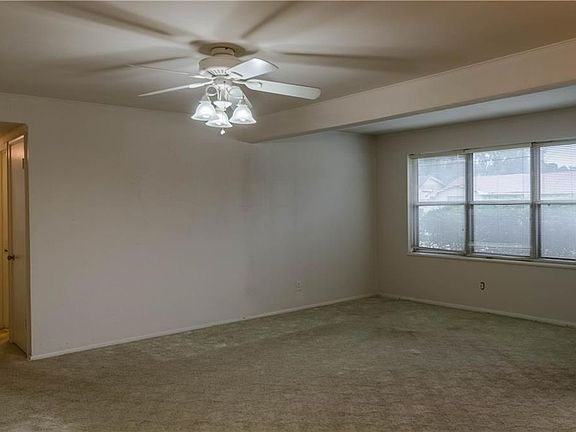 Another view of the living room, and the hall leading back to the three beds and a bath.