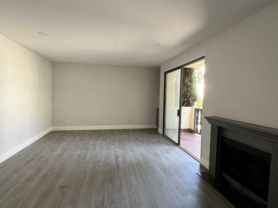 Living Room - With overhead lighting, fireplace, balcony and windows facing Goshen Ave