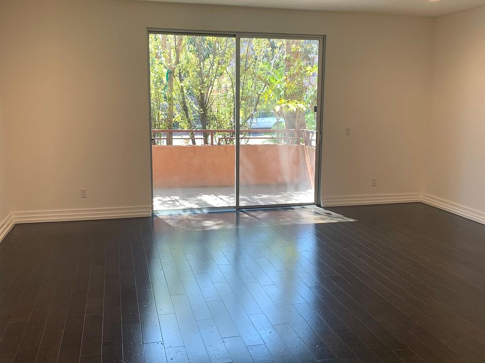Living Room with 8 ft sliding door leading to balcony.