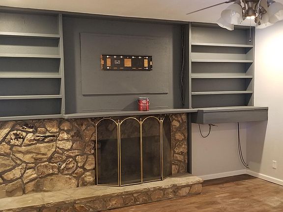 Built in shelves and wood burning fireplace in the living room