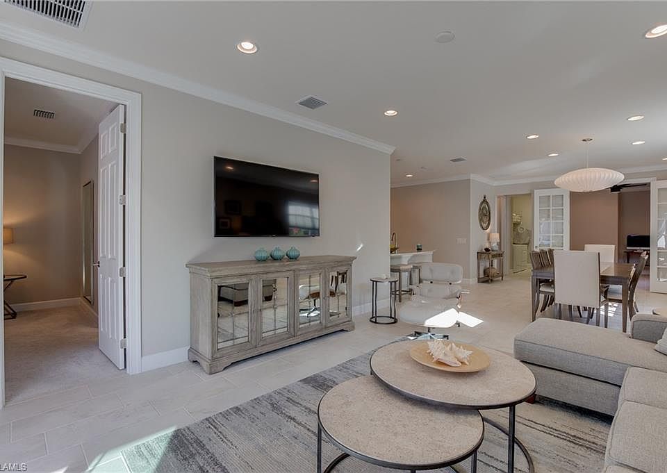 Living room with 65" flat screen TV for wireless streaming through your device. Leather chair not included.