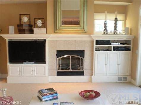There is a gas log fireplace surrounded with custom cabinets in the living room!
