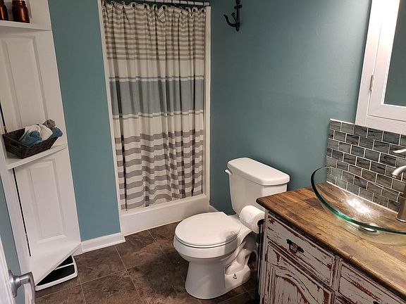Crisp and clean looking first floor bath. Custom made corner storage shelf.