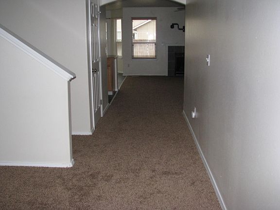 looking from front door towards open kitchen & great room w/fireplace