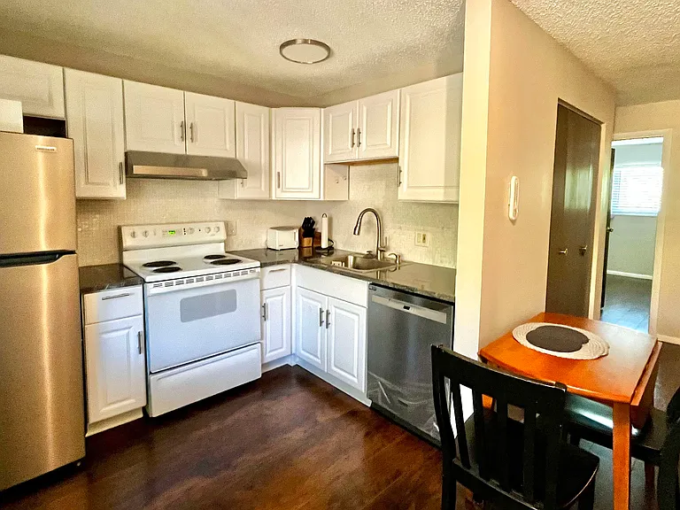 Renovated kitchen, well-equipped with new appliances- fridge, dishwasher, microwave, toaster, blender, coffee maker, dinnerware & utensils.