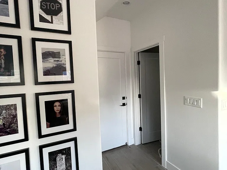 From the living room, looking toward the half bath and the door to the 2 car garage.