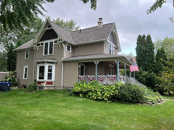 side view of home with beautiful landscaping
