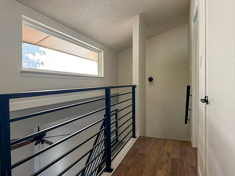 Upstairs hallway with panoramic window hall closet