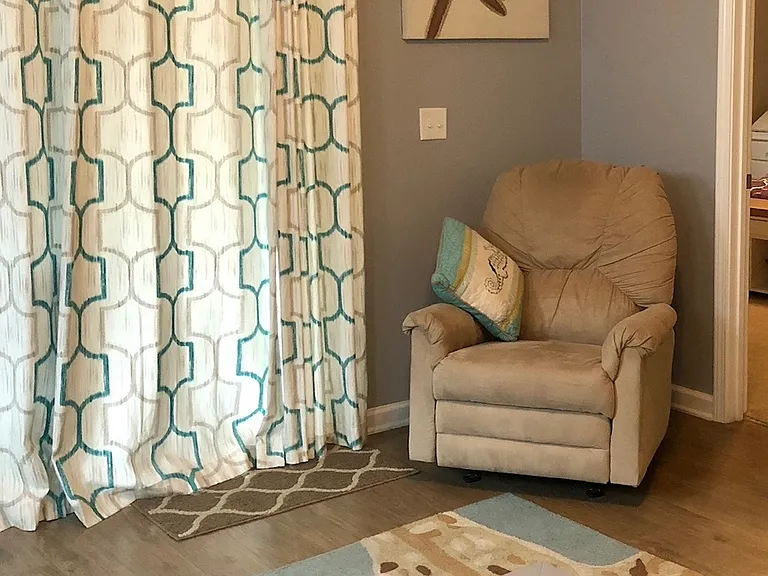 View from couches toward sliding door & master bedroom entry