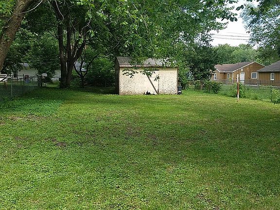 Fully fenced back yard and storage shed.
