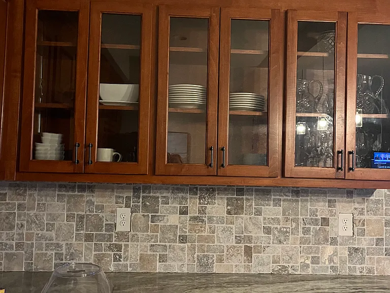 One side of the cabinets has glass doors.