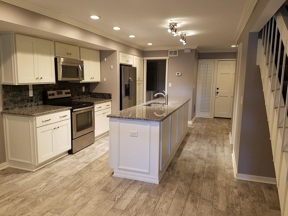 Open kitchen with island. Tile floors that look like wood