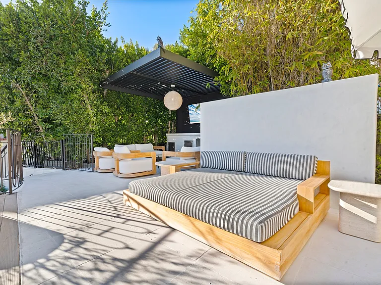 A sunlit lounge offering shaded comfort with custom finishes and timeless design.