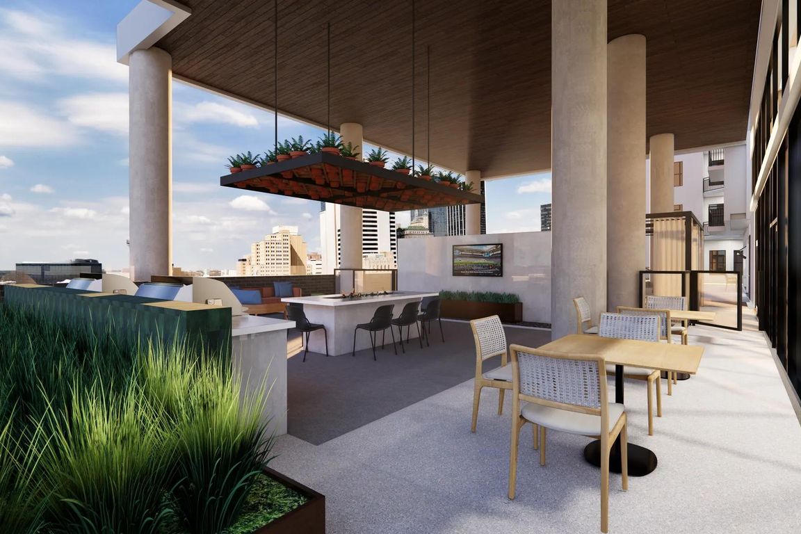 Poolside wrap-around covered amenity deck with grilling, TV wall, bar cooler table, fire table, and lounge seating.
