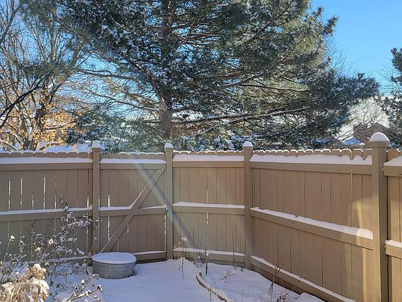 Fenced in back yard with patio and gardening areas.