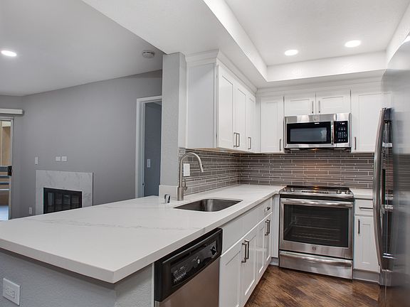 Kitchen complete with quartz countertops and wood flooring