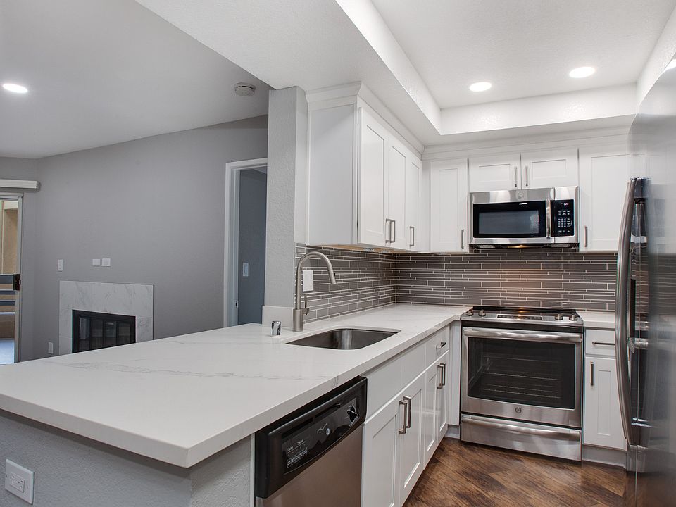 Kitchen complete with quartz countertops and wood flooring