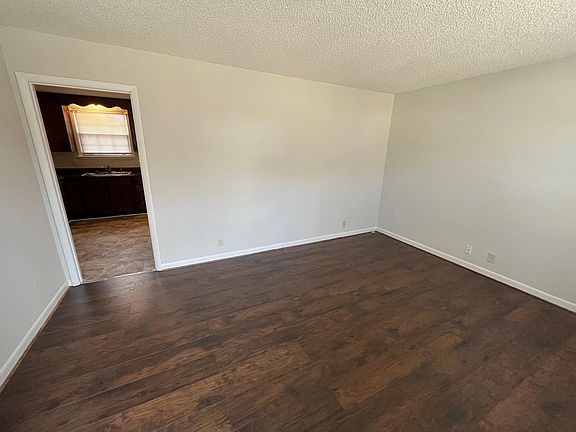 standing at the front door, looking into the LR, and beyond that, into the kitchen