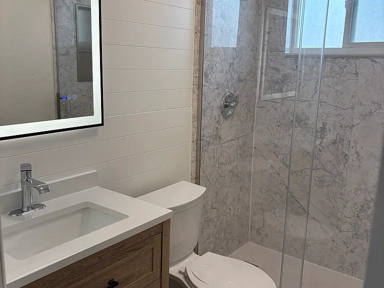 New walk in shower, lighted mirror, vanity and toilet