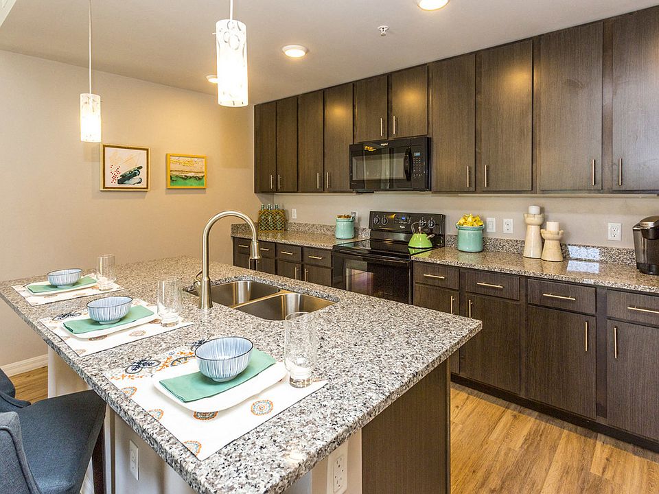 Coralina Apartments | Cape Coral, FL | Sleek Modern Kitchen with Granite Countertops