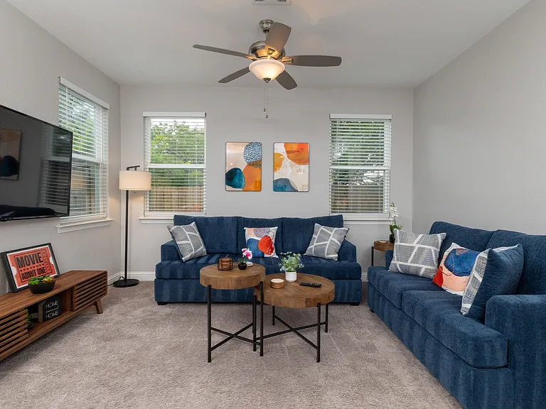 Spacious open living room with two comfy couches and a large flat-screen TV_perfect for relaxing nights in or movie marathons.