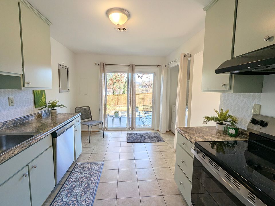 Kitchen opens to patio and large yard. Brand NEW dishwasher + electric range