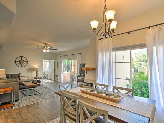 Photos highlight a stylish dining area and an elegant living room with lovely view and Fireplace.