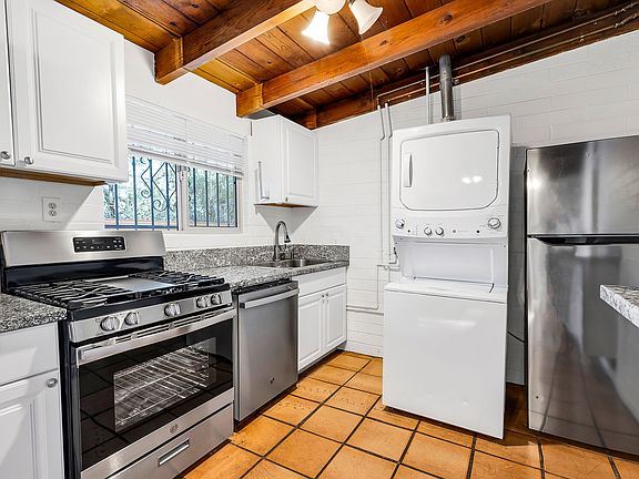 Kitchen with D/W, W/D, G/D full gas stove and large refrigerator