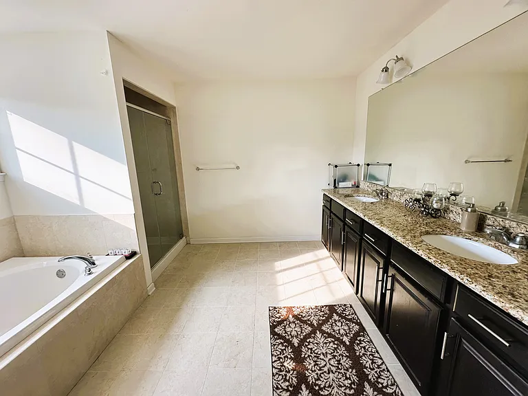 Master bathroom with large bathtub and walking in shower