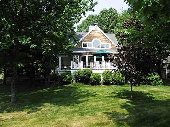 Elevated approach with elegant yet manageable lawn