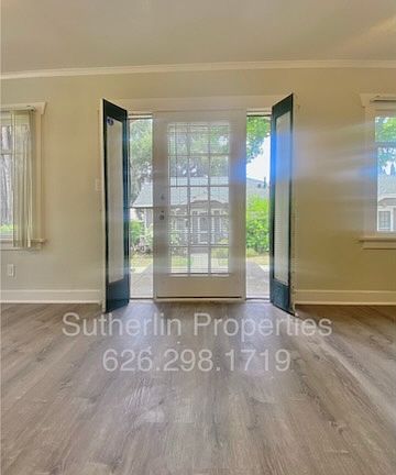 Front door with beautiful glass screened panels that open to let in the breeze