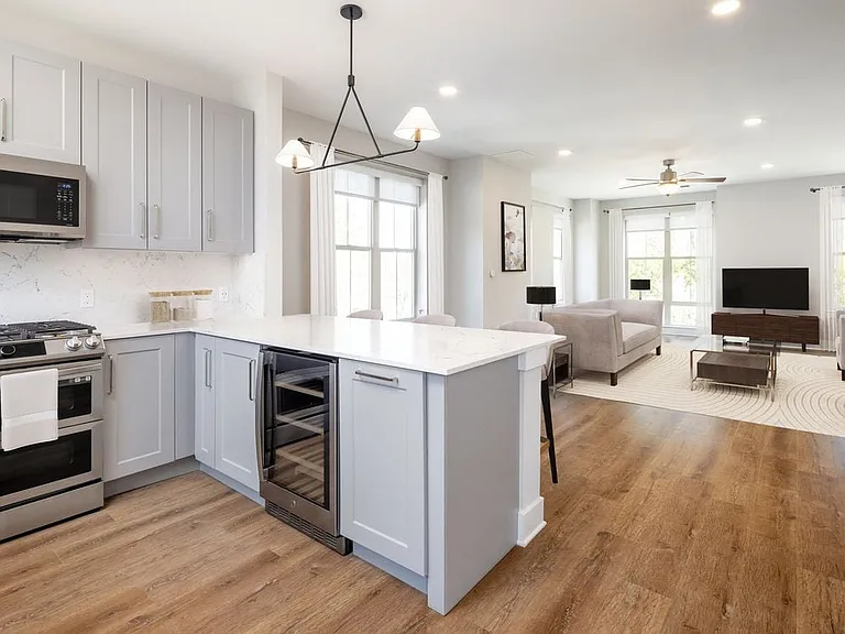 Signature Collection kitchen and living room with hard surface flooring