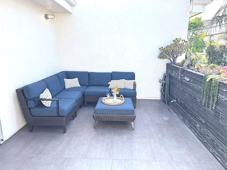 Open patio with dartboard and sofa set