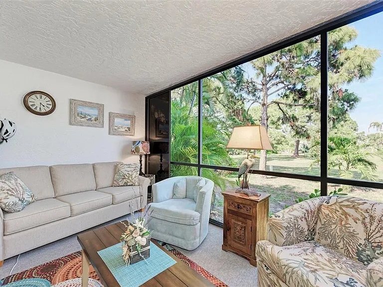 The soundtrack of paradise. __ Sink into the plush couch or find your rhythm in our swivel rocking chairs while you listen to the birds of the Lemon Bay Preserve. This open, airy lanai is designed for slow mornings and peaceful afternoons.