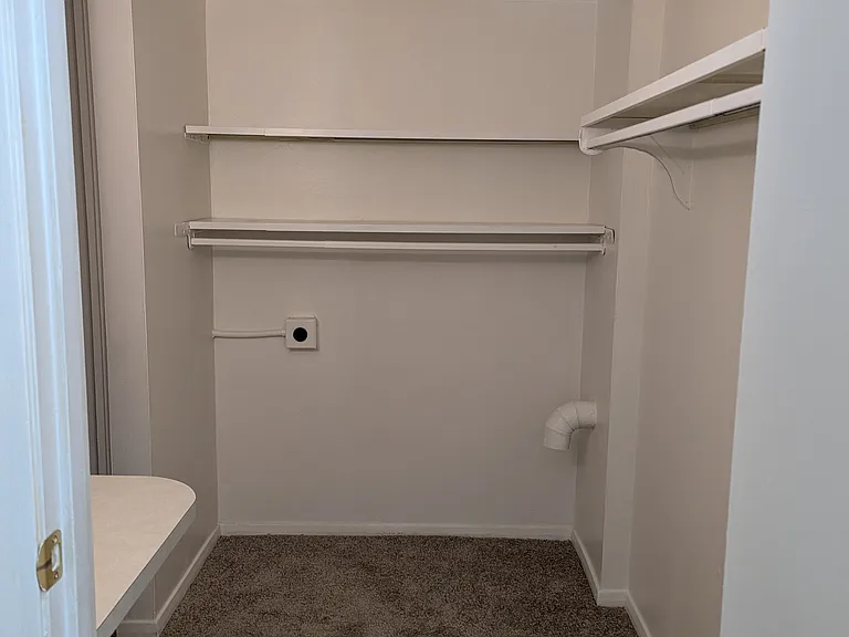 Walk in closet off larger bedroom