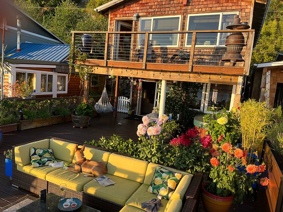 Beach house at summer at sunset. Both decks have a view to Gig Harbor and the Narrows Bridge.