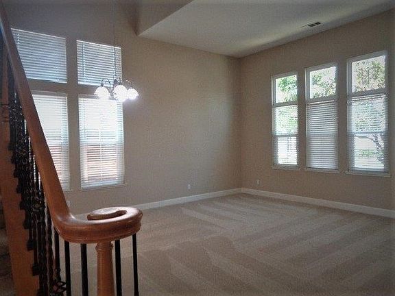 Elegant formal living & dining room featuring plush new carpet, fresh decorator 2 tone paint, & new satin nickel lighting.