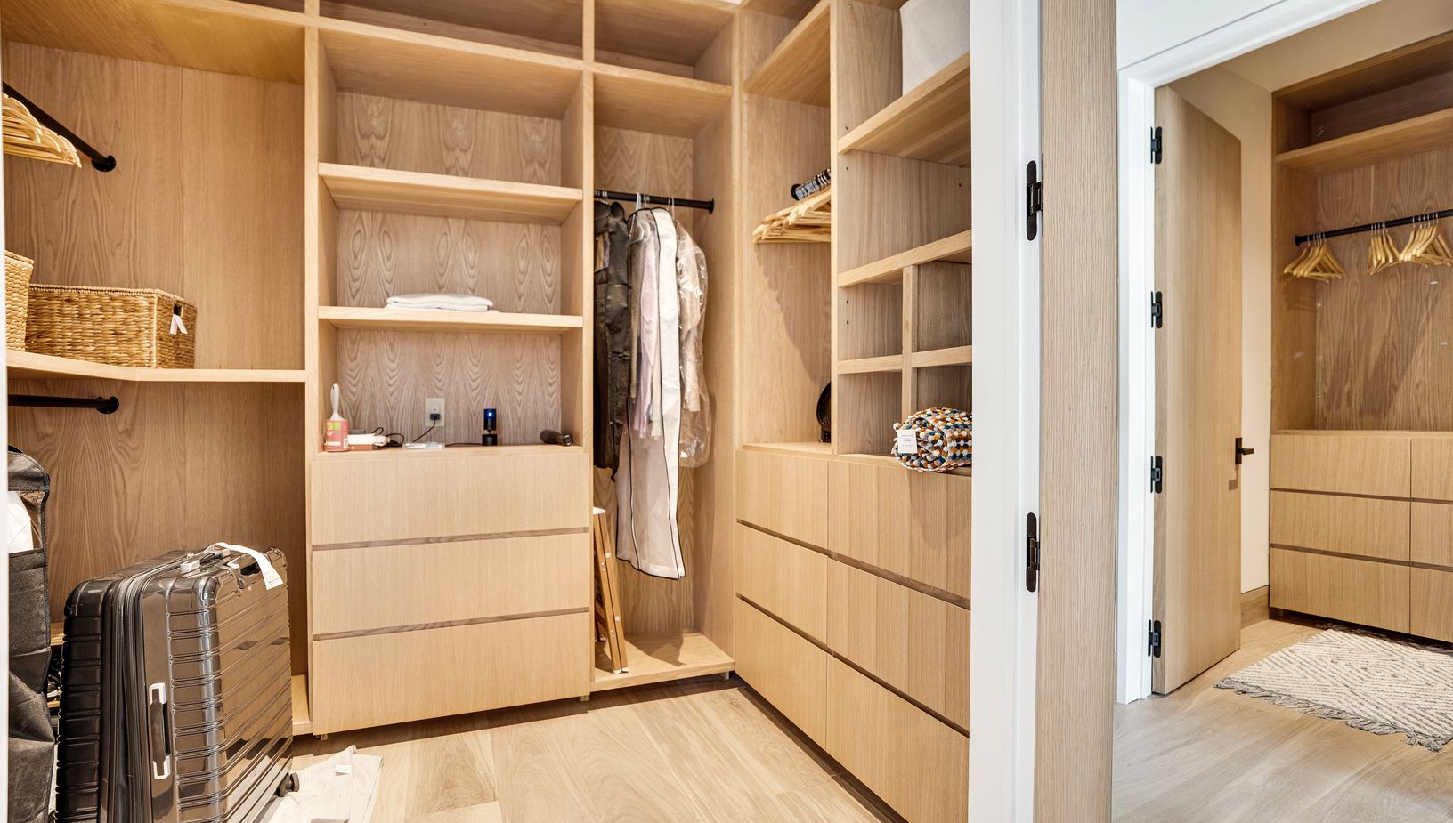  1 of 2 closet in the 2nd floor primary hallway leading to the bathroom 