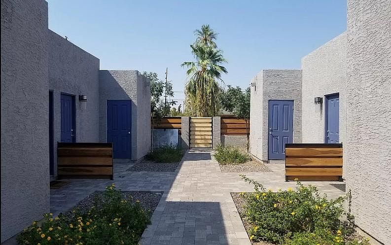 Common walkway into property, showing front door and private laundry room/storage door (for each unit).