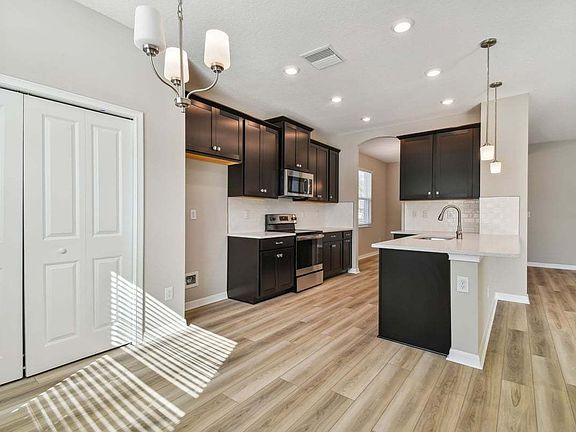 Juno new construction quick move-in home plan cafe and kitchen at Emerald Acres 5005 Emerald Acres W