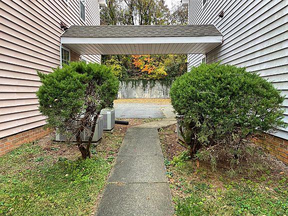 Walk way to back parking and trash/recycling bins between the two buildings