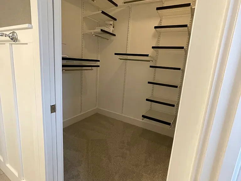 Primary Closet w/ custom ELFA organization (and stackable laundry not shown)